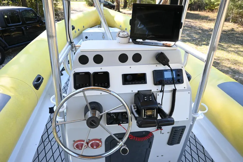 Slide: The Image of 2007 Ribcraft 9.0 boat dashboard with steering wheel and navigation equipment. - 14