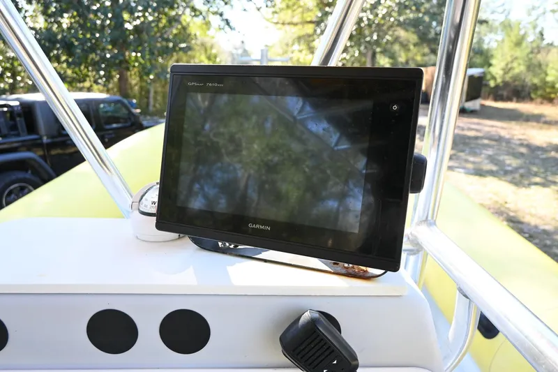 Slide: The Image of Garmin display on 2007 Ribcraft 9.0 boat console, surrounded by trees. - 15