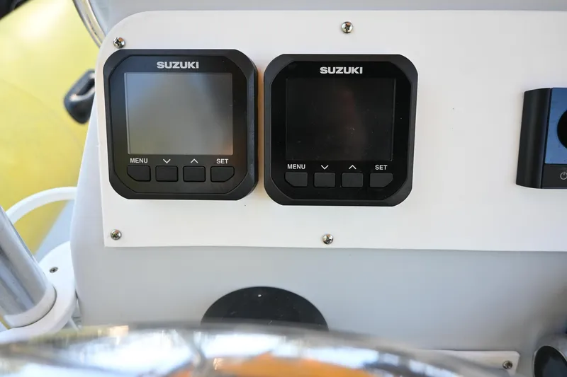 Slide: The Image of Suzuki marine gauges on a 2007 Ribcraft 9.0 dashboard. - 16