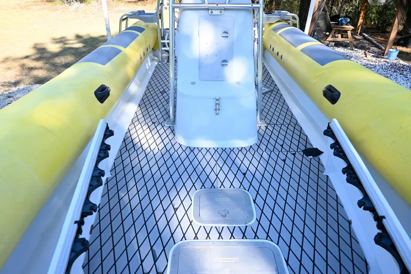 Slide: The Image of 2007 Ribcraft 9.0 boat interior with yellow inflatable sides and diamond-patterned deck. - 22