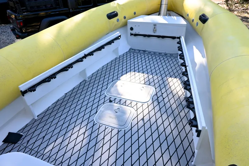 Slide: The Image of 2007 Ribcraft 9.0 boat interior with yellow inflatable sides and diamond-patterned deck. - 24