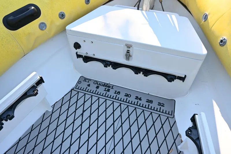 Slide: The Image of 2007 Ribcraft 9.0 boat interior with storage box and measurement mat. - 25