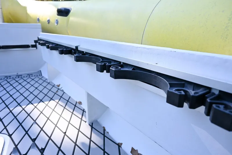 Slide: The Image of Ribcraft 9.0 boat interior detail, 2007 model, featuring yellow inflatable tube and black netting. - 26