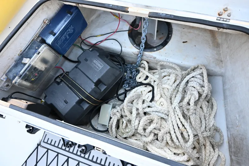Slide: The Image of Storage compartment of 2007 Ribcraft 9.0 with battery, ropes, and chain. - 29