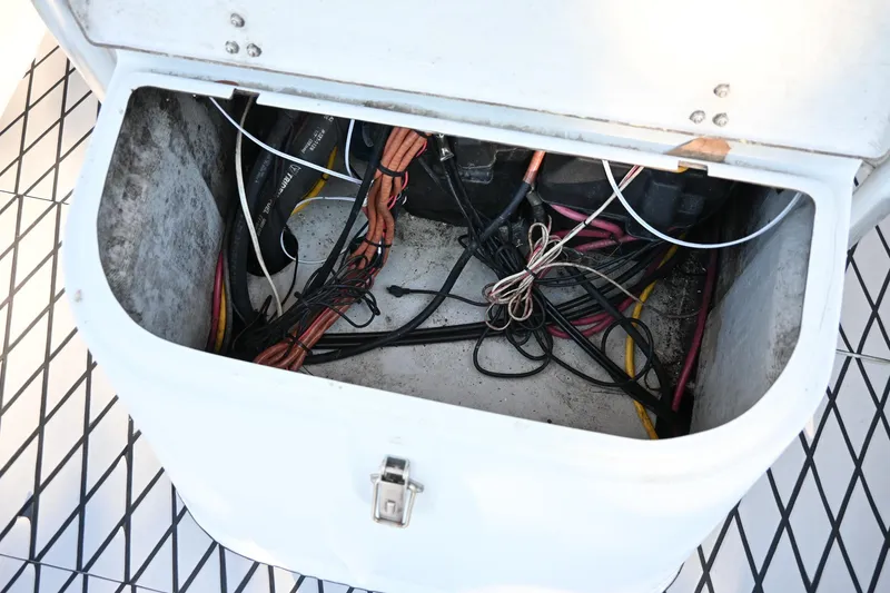 Slide: The Image of Open storage compartment with wiring in a 2007 Ribcraft 9.0 boat. - 33