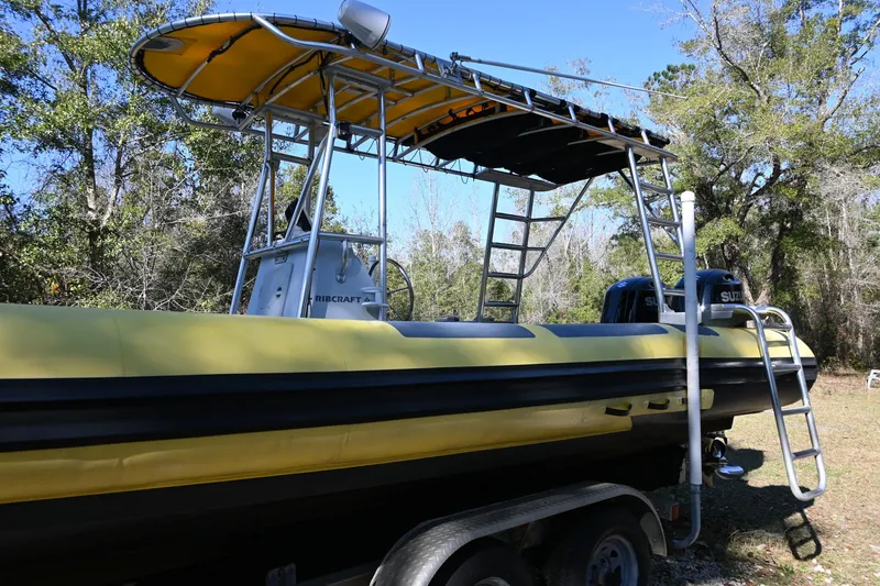 Slide: The Image of 2007 Ribcraft 9.0 boat on trailer, yellow and black, with canopy and ladder, outdoors. - 4
