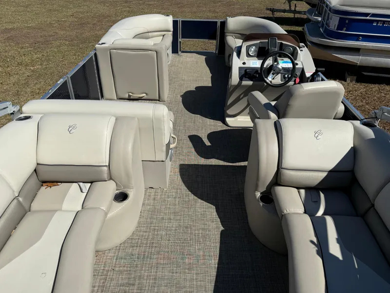 Slide: The Image of 2022 Cypress Cay Seabreeze 232 pontoon boat interior with beige seating and steering console. - 3