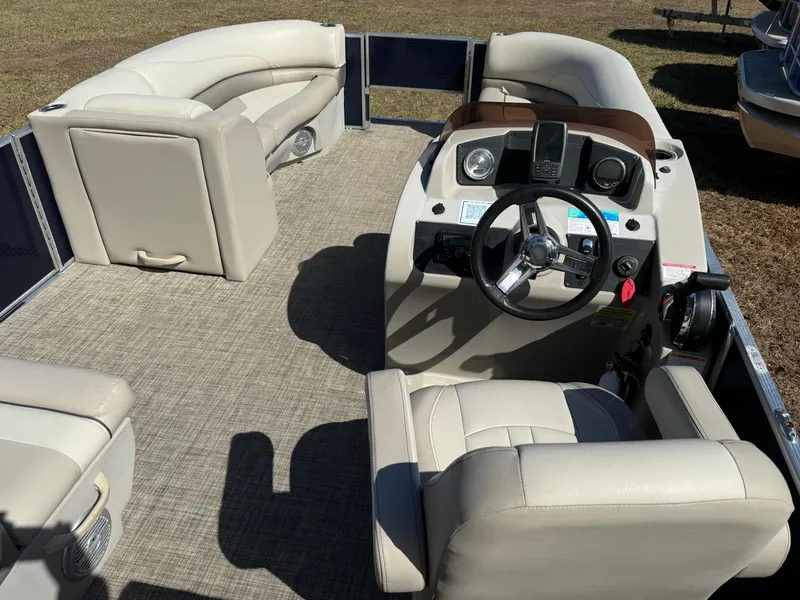 Slide: The Image of 2022 Cypress Cay Seabreeze 232 pontoon boat interior with beige seating and steering console. - 6