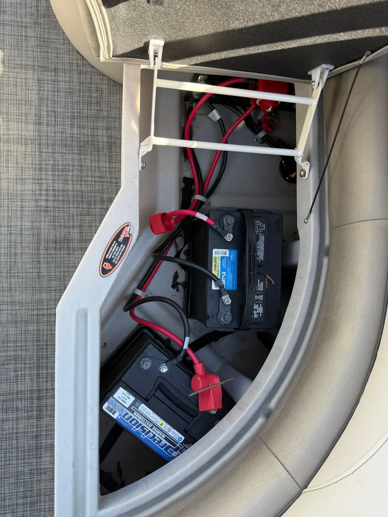 Slide: The Image of 2022 Cypress Cay Seabreeze 232 boat battery compartment with wiring and connections. - 7