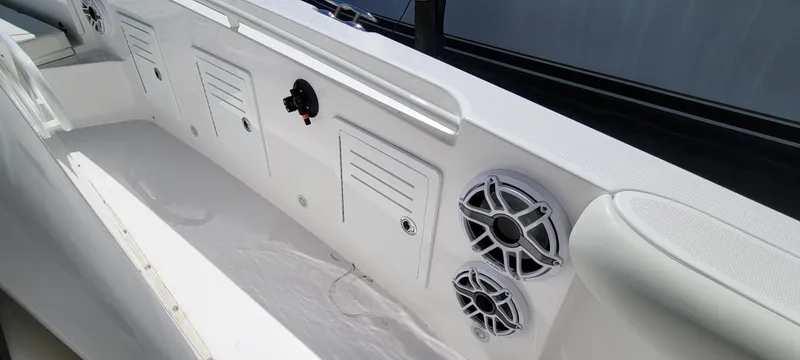 Slide: The Image of 2024 Everglades 365 Center Console boat interior with storage compartments and speakers. - 17