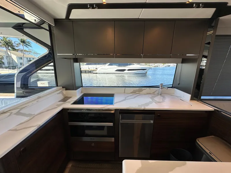 Slide: The Image of Interior of 2023 Sunseeker 65 Sport Yacht kitchen with modern appliances and waterfront view. - 10