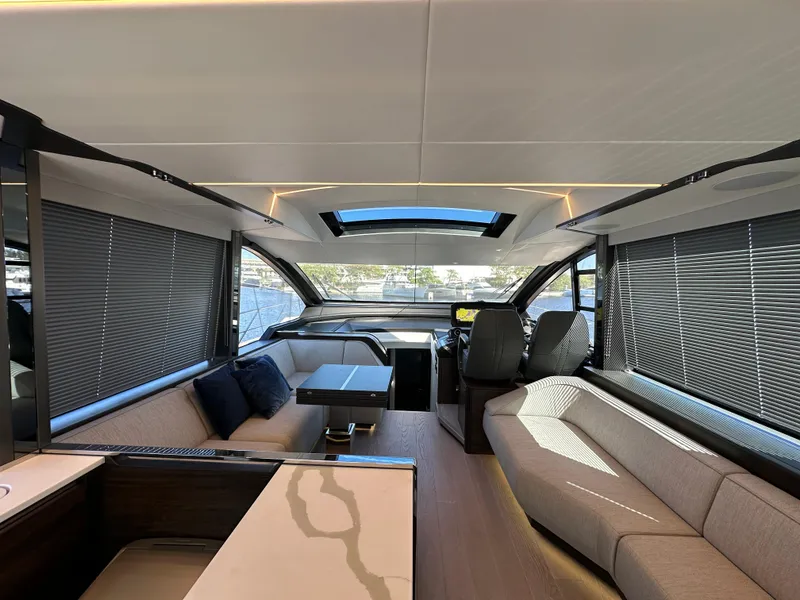 Slide: The Image of Interior of 2023 Sunseeker 65 Sport Yacht, featuring modern seating and panoramic windows. - 12