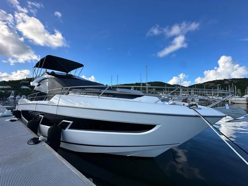 Slide: The Image of 2023 Sunseeker 65 Sport Yacht docked at marina under blue sky. - 25