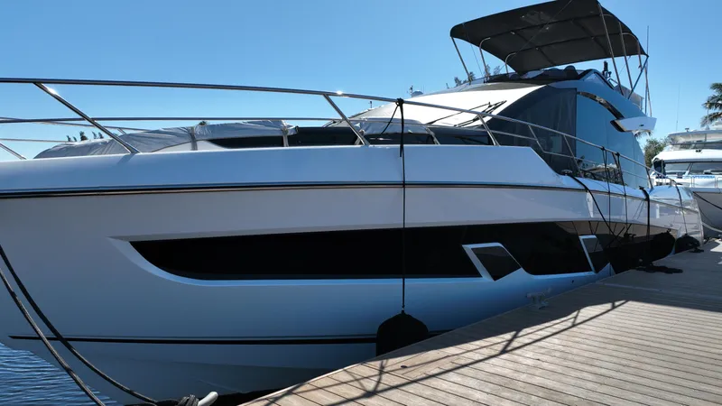 Slide: The Image of 2023 Sunseeker 65 Sport Yacht docked, showcasing sleek design and modern features. - 3