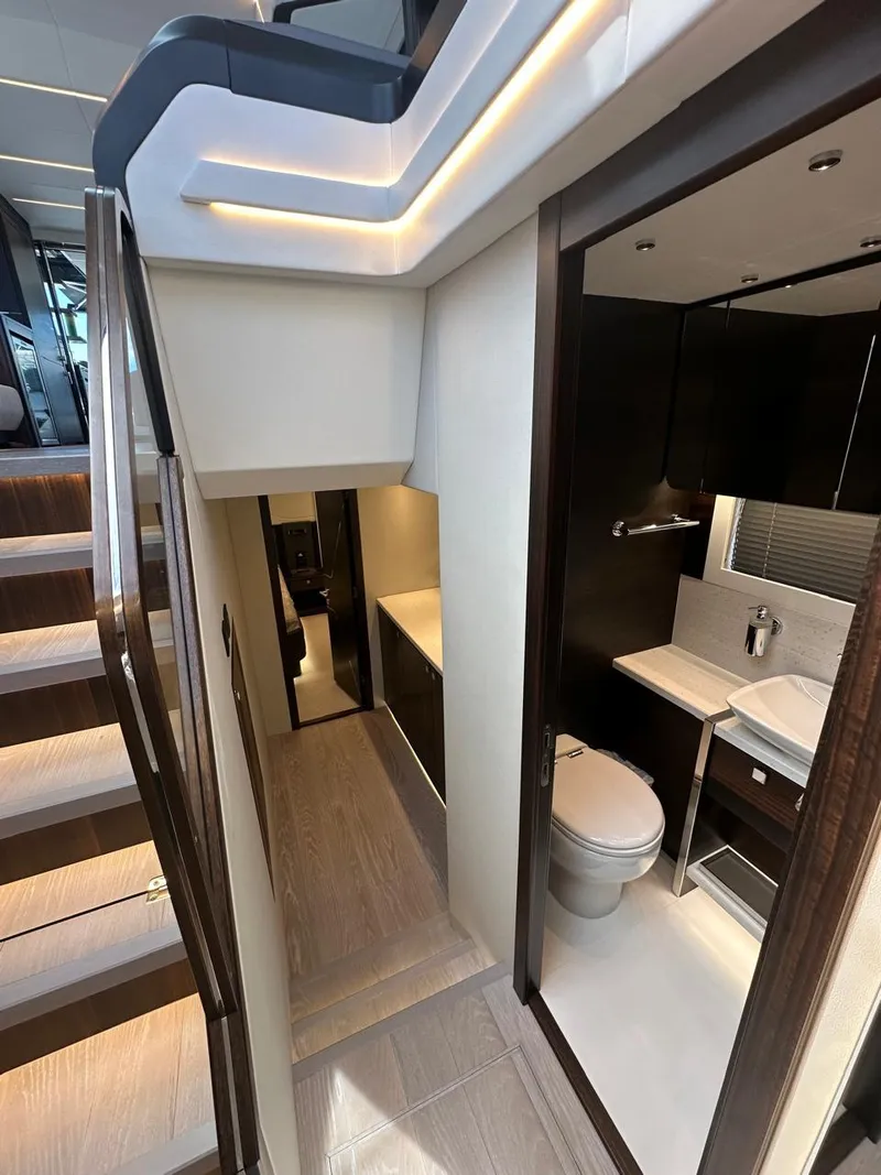 Slide: The Image of Interior of 2023 Sunseeker 65 Sport Yacht, featuring modern bathroom and staircase. - 30