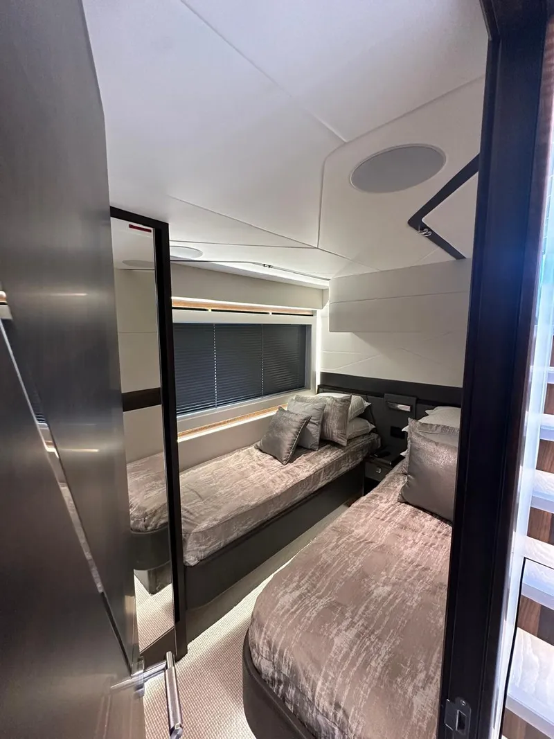 Slide: The Image of 2023 Sunseeker 65 Sport Yacht cabin with twin beds and modern interior design. - 31