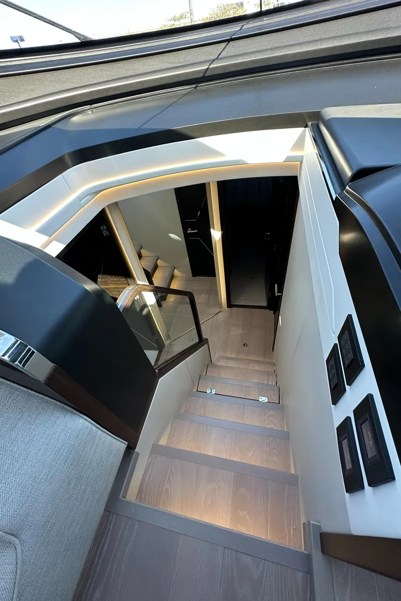 Slide: The Image of Interior staircase of 2023 Sunseeker 65 Sport Yacht, featuring modern design and ambient lighting. - 33