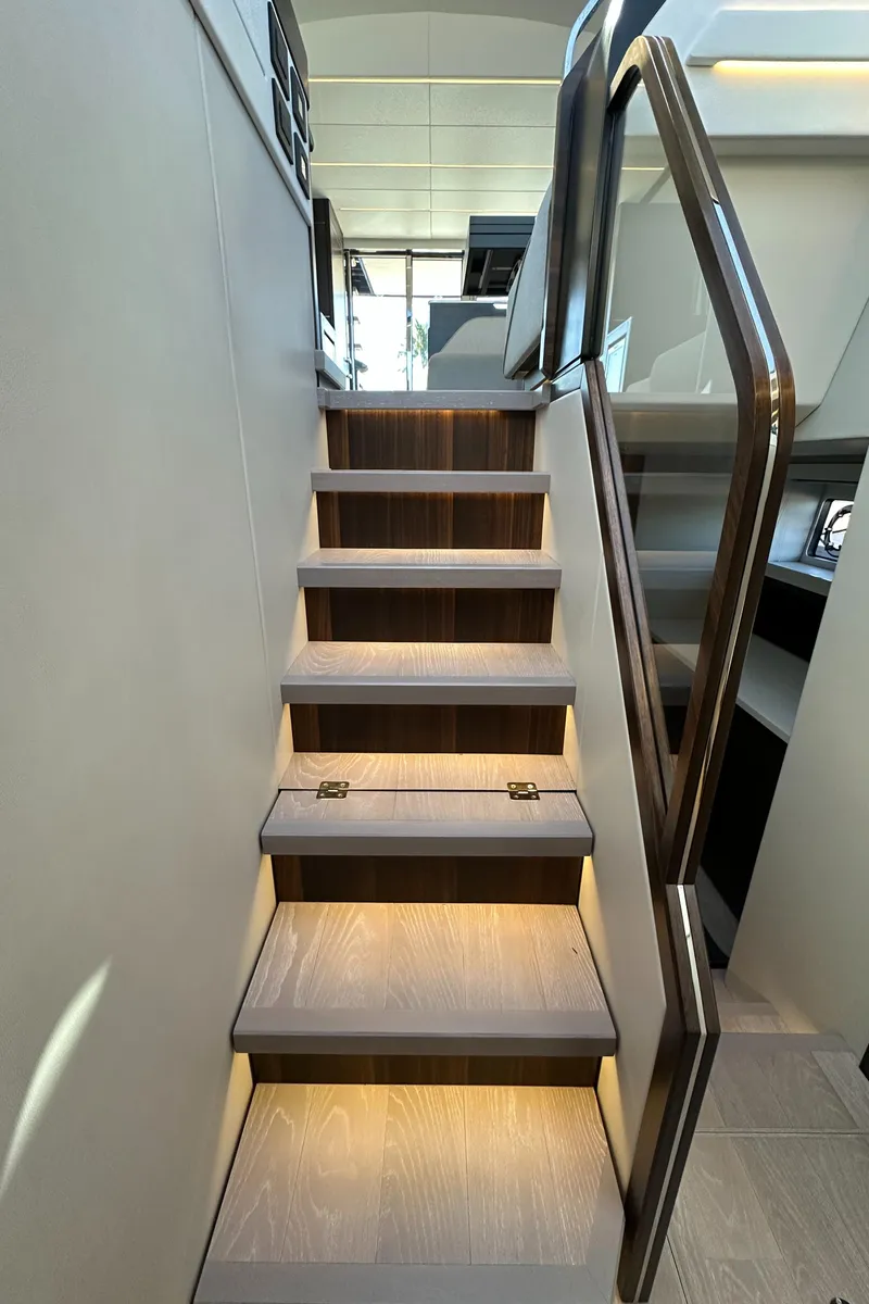 Slide: The Image of Staircase inside 2023 Sunseeker 65 Sport Yacht with modern lighting and sleek design. - 34