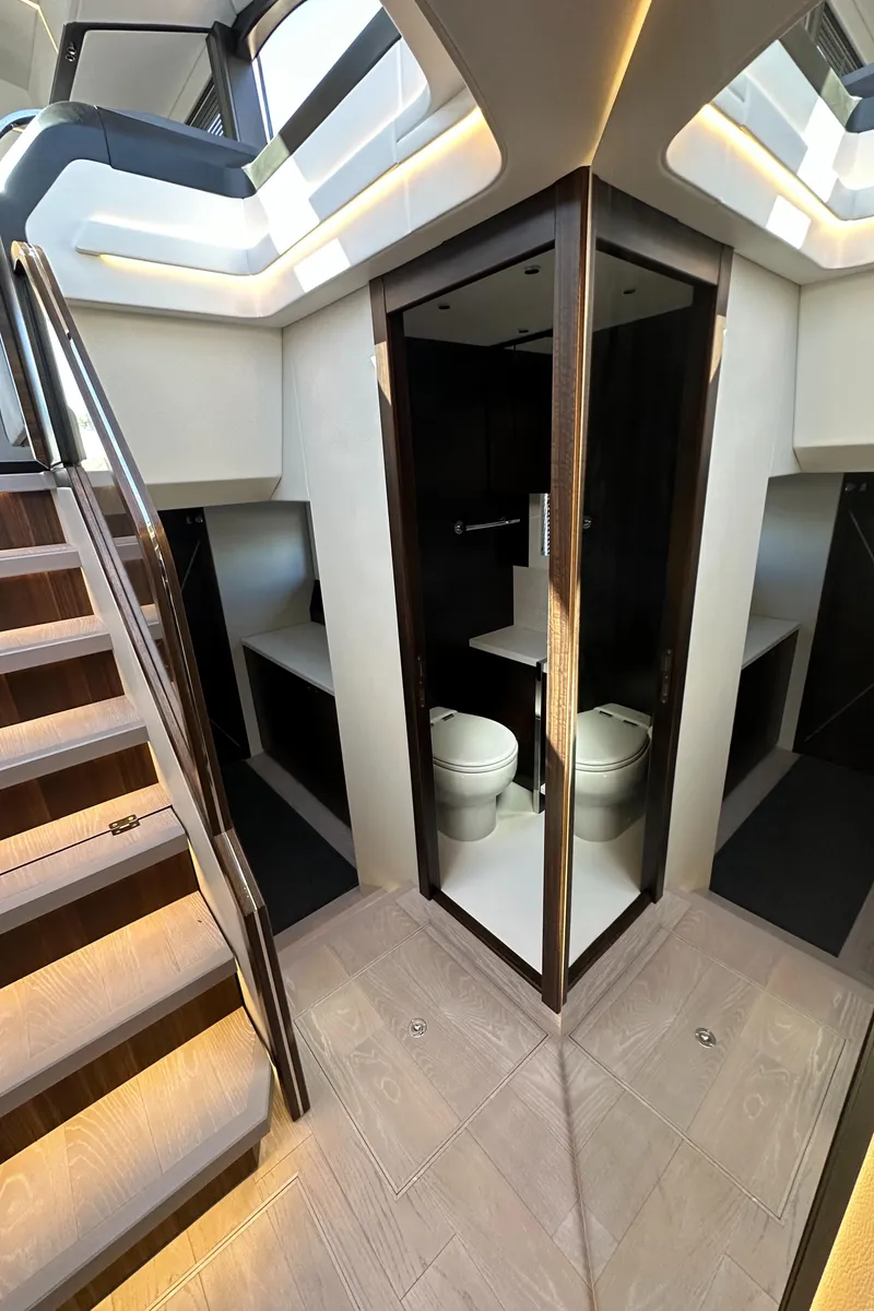 Slide: The Image of 2023 Sunseeker 65 Sport Yacht interior with modern bathroom and staircase design. - 38