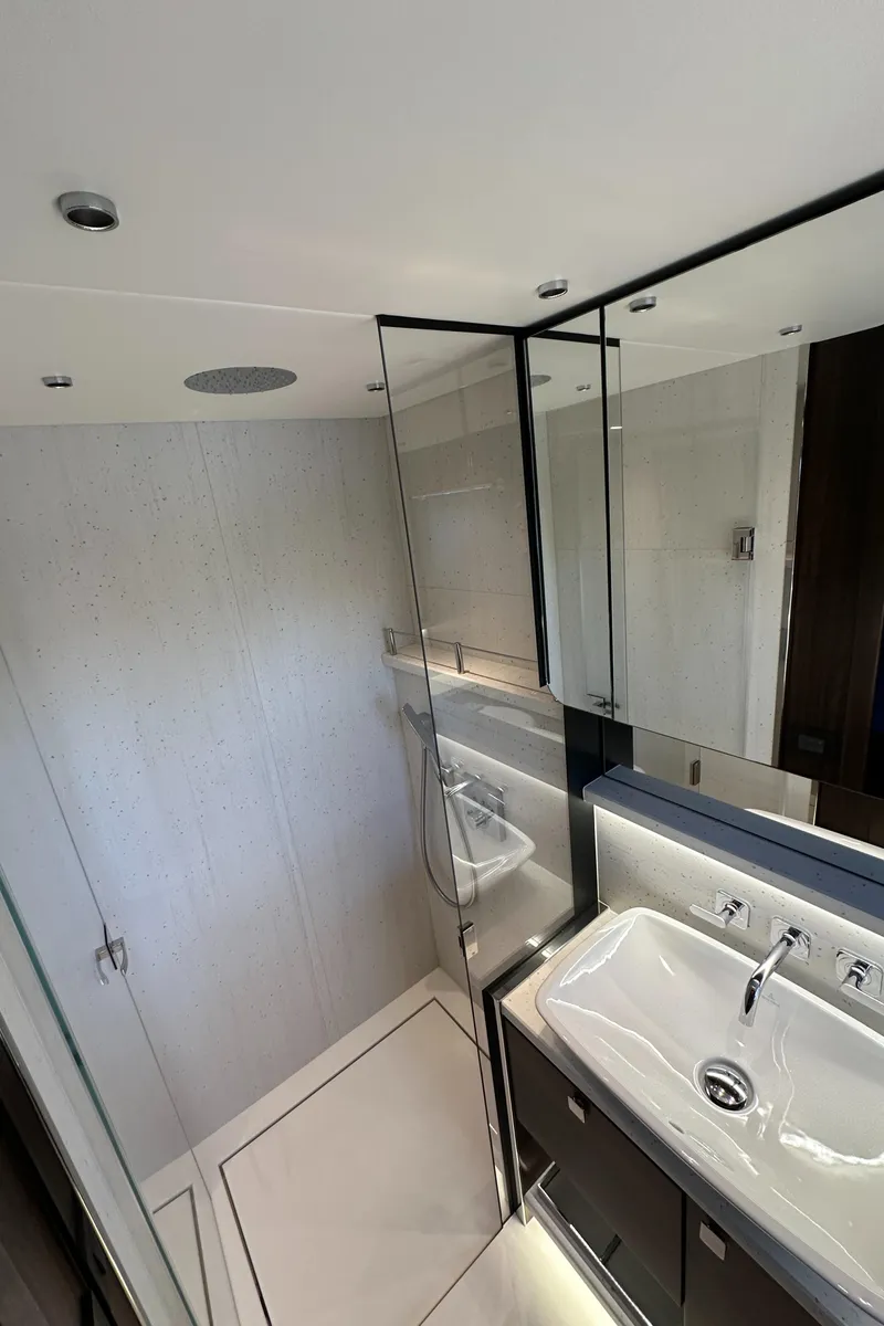 Slide: The Image of 2023 Sunseeker 65 Sport Yacht bathroom with modern sink and mirrored walls. - 42