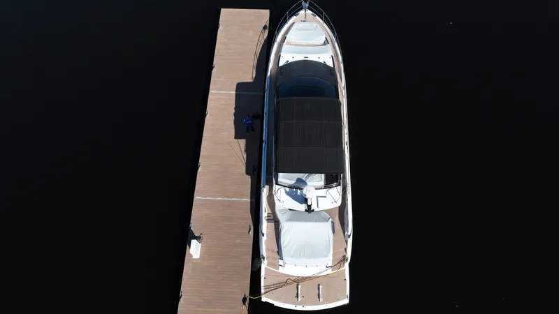 Slide: The Image of Aerial view of 2023 Sunseeker 65 Sport Yacht docked at a pier. - 8