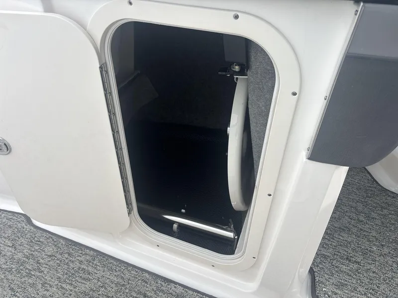 Slide: The Image of Open storage compartment on a 2017 Chaparral 203 Vortex boat. - 15