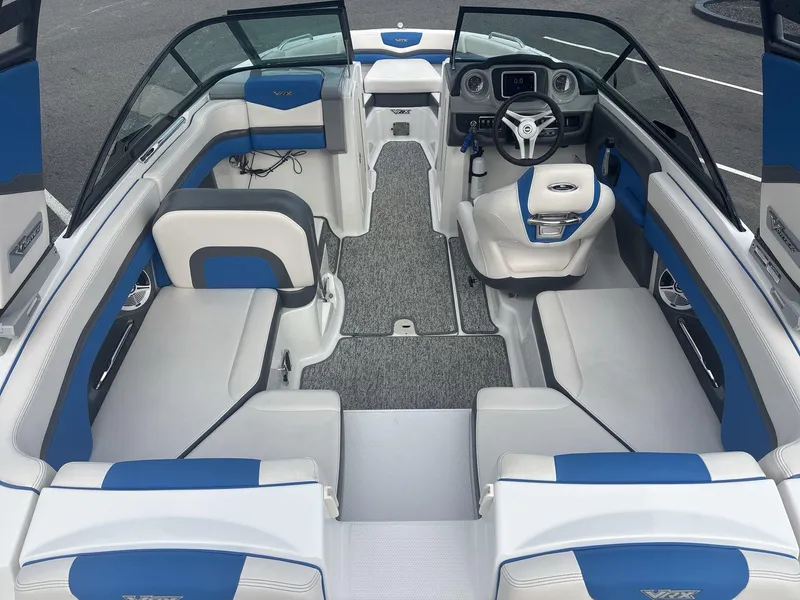 Slide: The Image of 2017 Chaparral 203 Vortex boat interior with blue and white seating and steering console. - 5