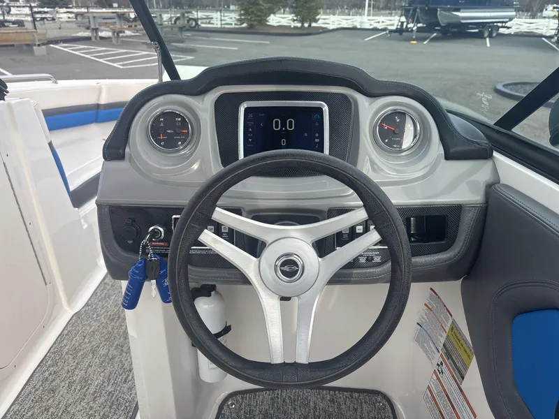 Slide: The Image of Steering wheel and dashboard of 2017 Chaparral 203 Vortex boat, featuring gauges and controls. - 9