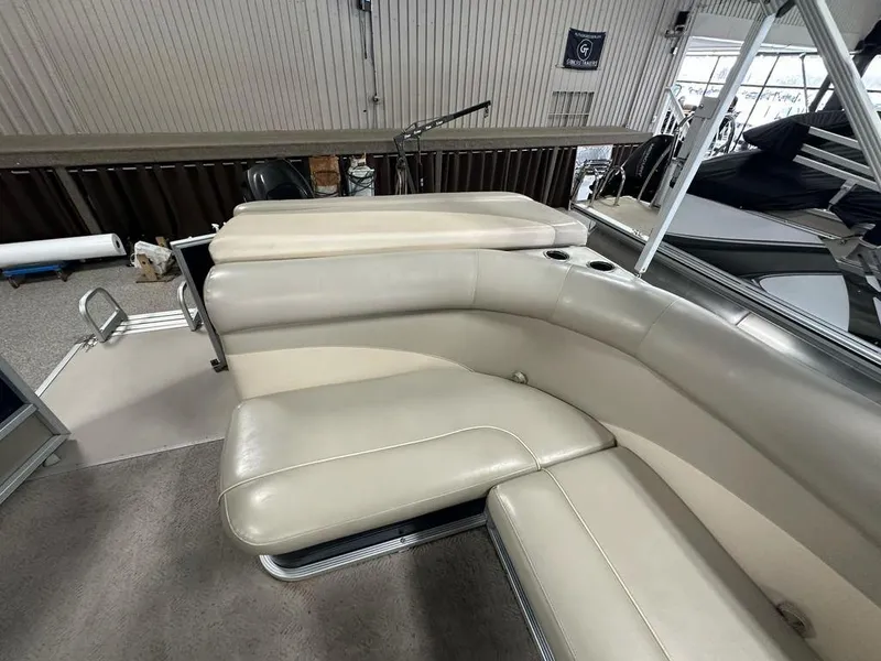 Slide: The Image of 2013 Crest II 210 Series boat interior with beige seating and cup holders. - 11