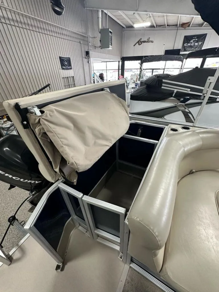 Slide: The Image of 2013 Crest II 210 Series boat interior with storage compartment and seating. - 12