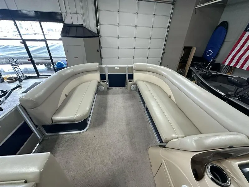 Slide: The Image of Interior of a 2013 Crest II 210 Series pontoon boat with beige seating. - 3
