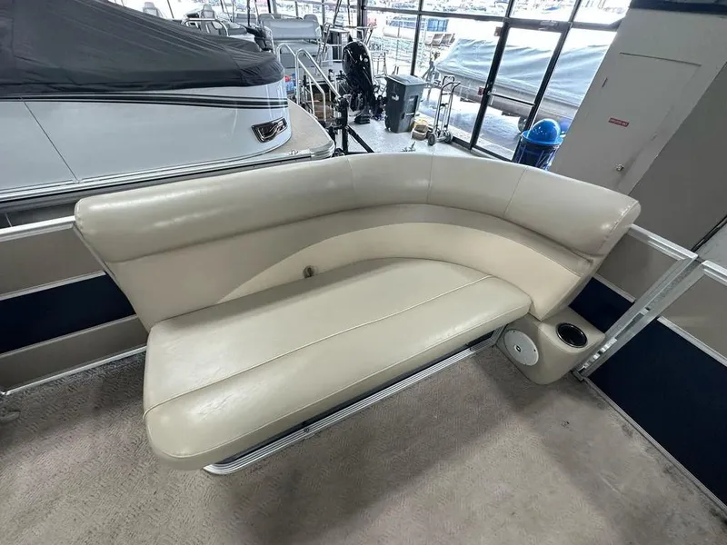 Slide: The Image of 2013 Crest II 210 Series boat interior with beige seating and cup holder. - 4