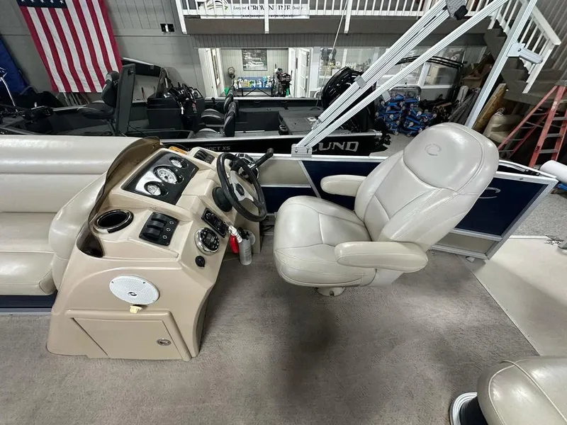 Slide: The Image of 2013 Crest II 210 Series boat interior with steering console and captain's chair. - 7