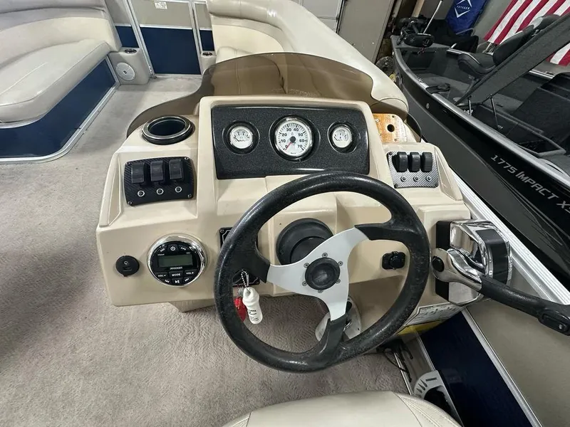 Slide: The Image of Steering console of a 2013 Crest II 210 Series boat with gauges and controls. - 8