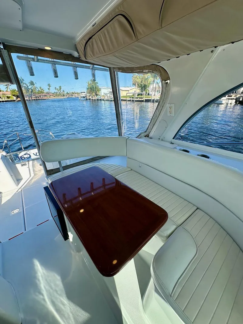 Slide: The Image of Interior of 2009 Glacier Bay 3080 boat with seating and table, overlooking water. - 10