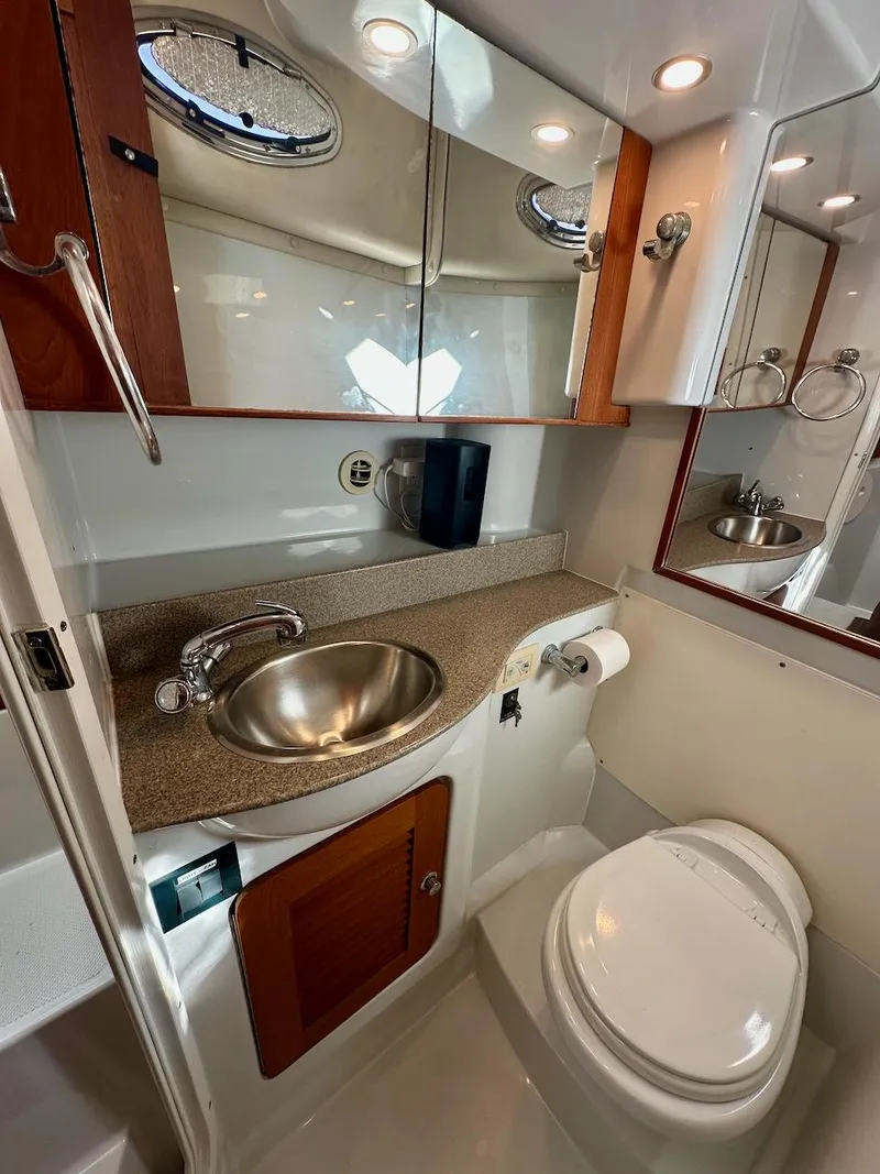 Slide: The Image of 2009 Glacier Bay 3080 boat bathroom with sink, mirror, and toilet. - 16