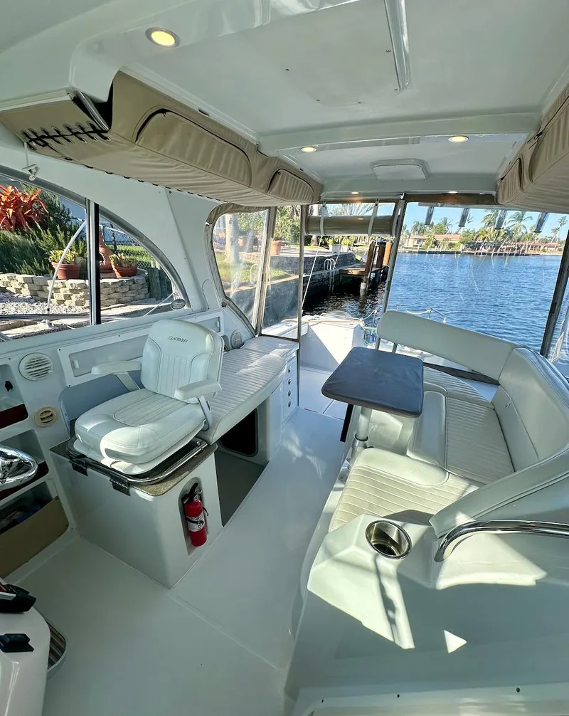 Slide: The Image of 2009 Glacier Bay 3080 boat interior with seating, table, and water view. - 7