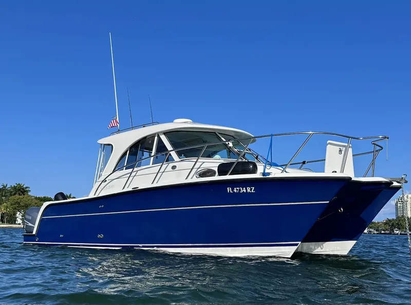 The Image of 2009 Glacier Bay 3080 boat on water, blue hull, clear sky background. - 0