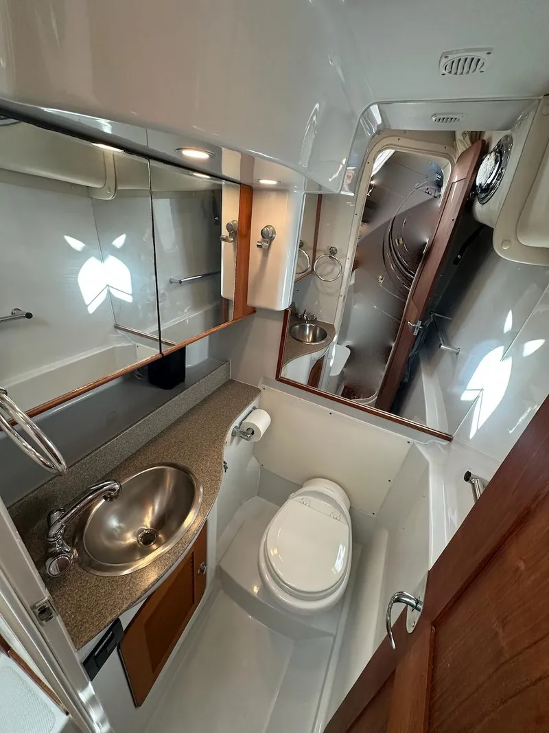 Slide: The Image of 2009 Glacier Bay 3080 boat bathroom with sink, toilet, and mirror. - 15