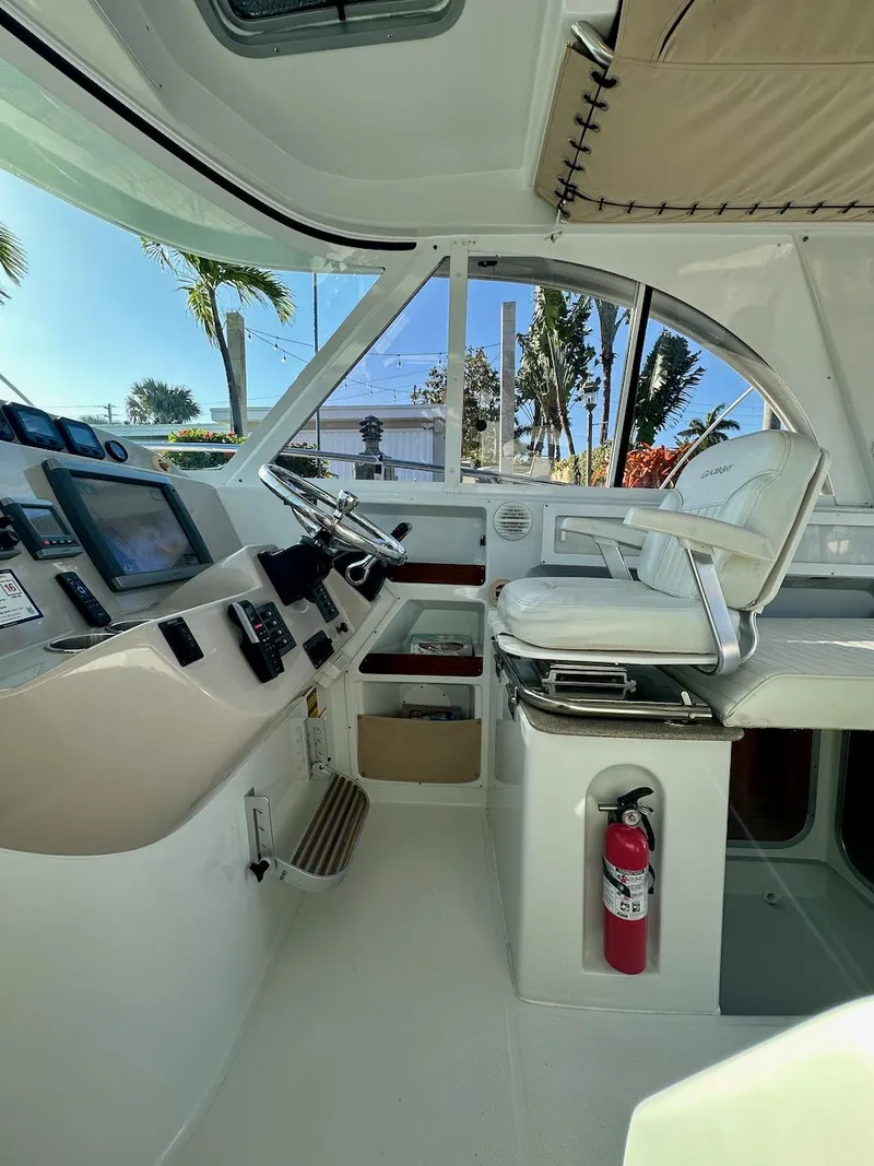 Slide: The Image of 2009 Glacier Bay 3080 boat cockpit with steering wheel, control panel, and captain's chair. - 9