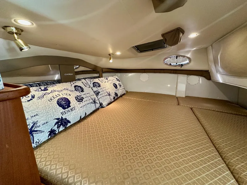 Slide: The Image of Cozy cabin interior of 2009 Glacier Bay 3080 with patterned bedding and ambient lighting. - 20