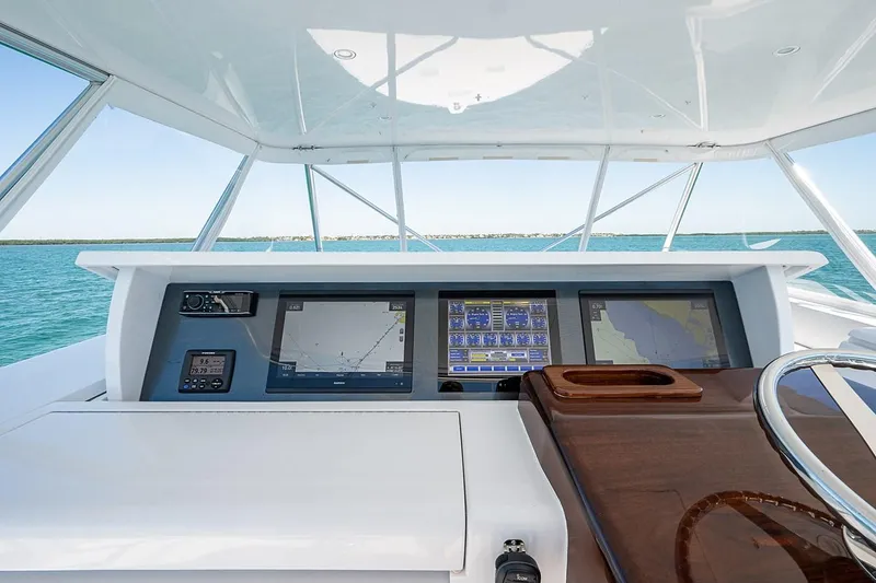Slide: The Image of Helm of 2008 Hatteras 68 Convertible yacht with navigation screens and steering wheel. - 35