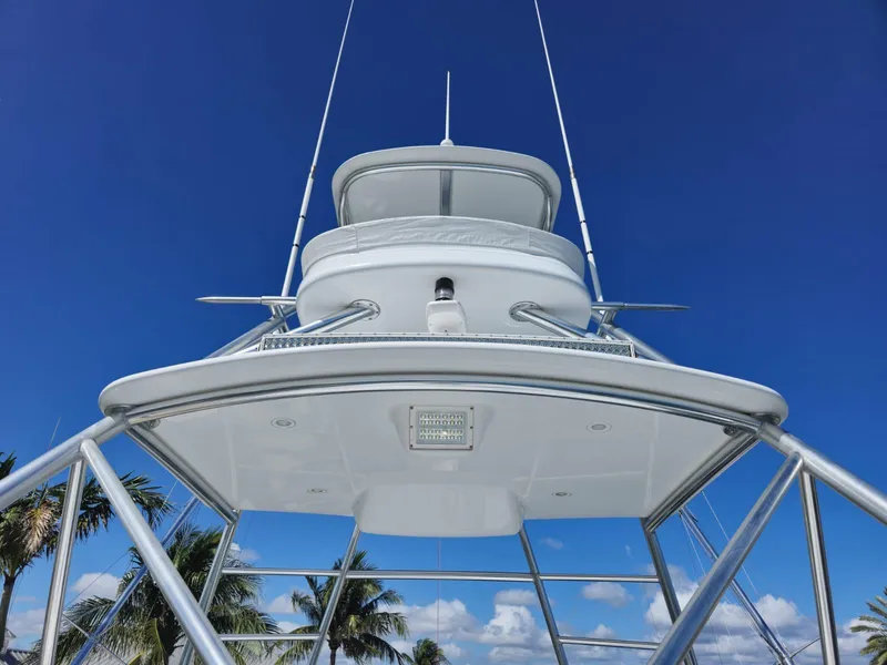 Slide: The Image of 2008 Hatteras 68 Convertible yacht tower against clear blue sky. - 43