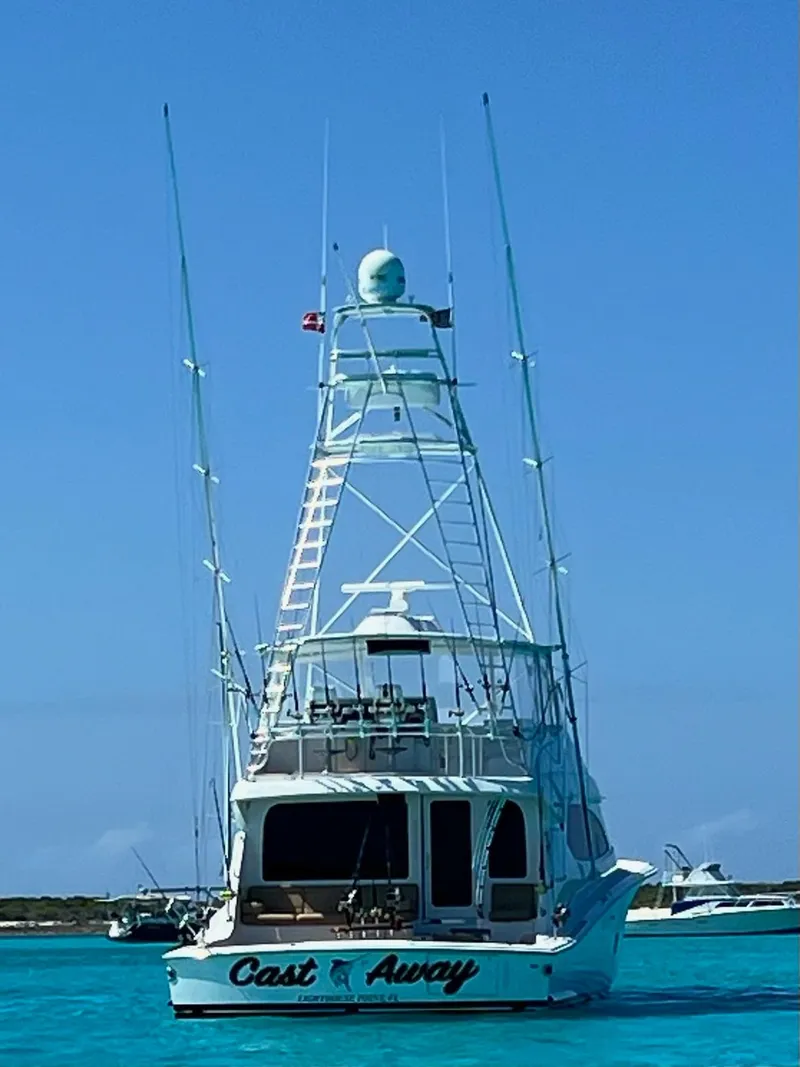 Slide: The Image of 2008 Hatteras 68 Convertible yacht on clear blue water, rear view. - 80
