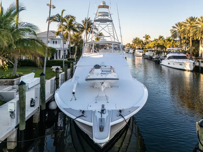 Slide: The Image of 2008 Hatteras 68 Convertible yacht docked in a scenic canal with palm trees. - 8