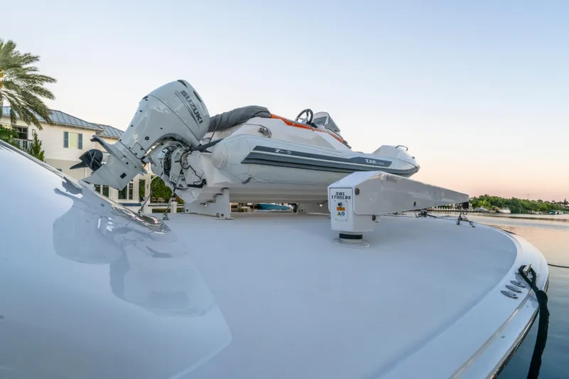 Slide: The Image of 2008 Hatteras 68 Convertible yacht with a mounted inflatable boat on deck. - 41