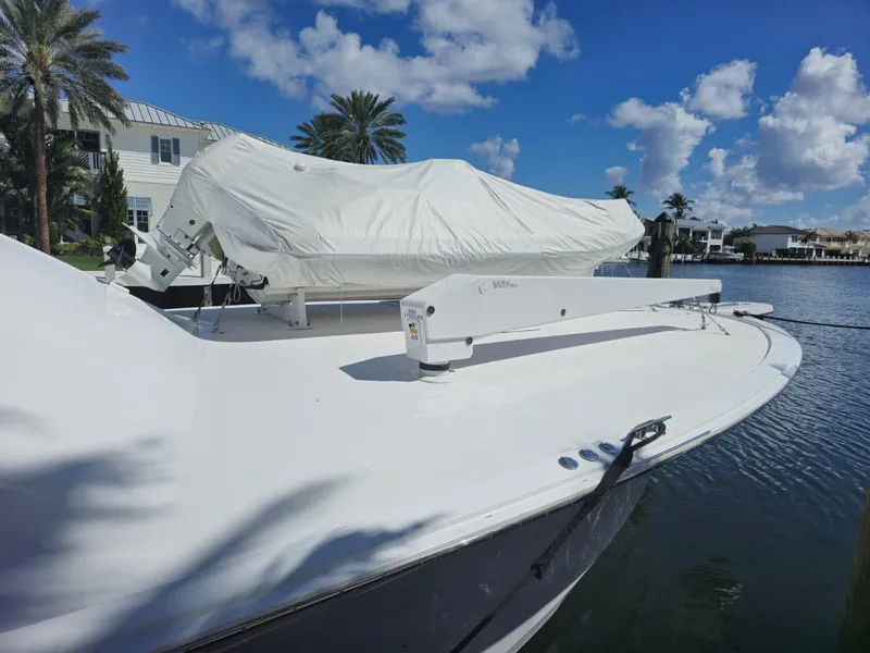 Slide: The Image of 2008 Hatteras 68 Convertible yacht docked under a clear blue sky. - 42