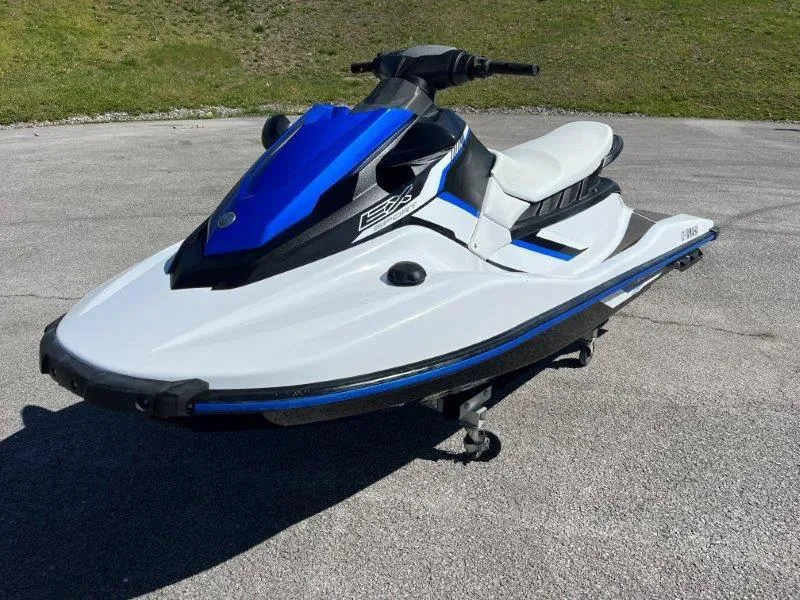 Slide: The Image of 2017 Yamaha WaveRunner EX Sport jet ski in blue and white on pavement. - 10