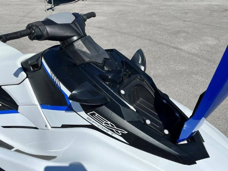Slide: The Image of 2017 Yamaha WaveRunner EX Sport jet ski, black and white design, parked on pavement. - 25