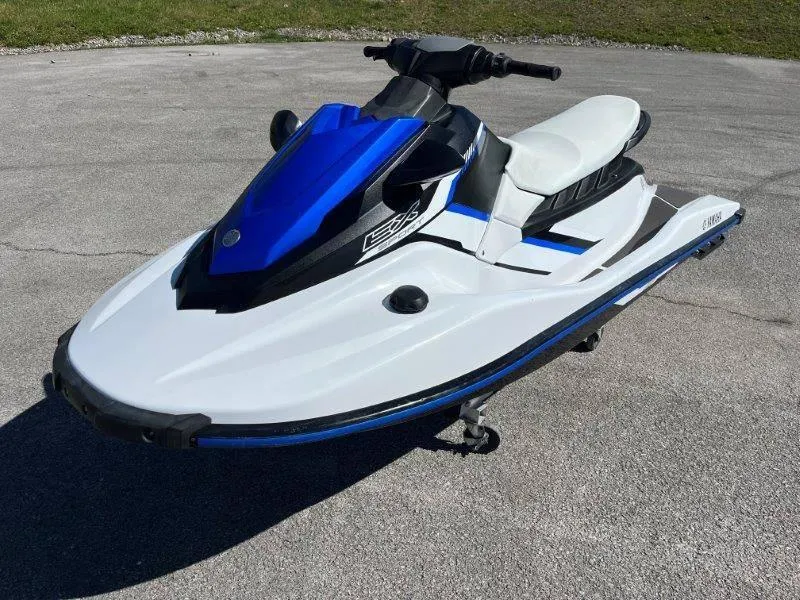 Slide: The Image of 2017 Yamaha WaveRunner EX Sport jet ski on pavement, featuring a sleek blue and white design. - 3